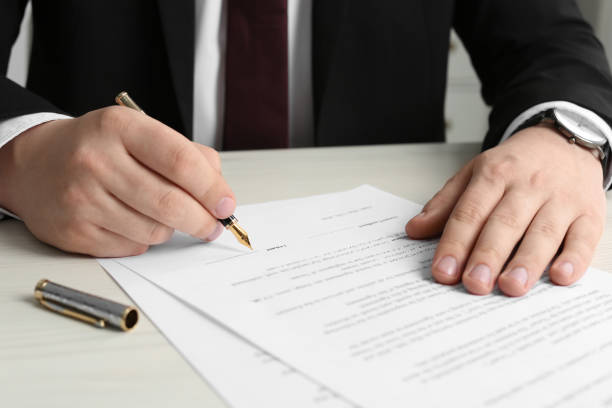 istock Notary signing document at wooden table, closeup 1728646552