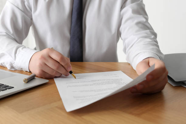 istock Notary signing document at wooden table, closeup 1728647130