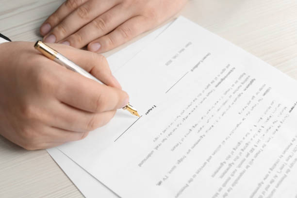 istock Notary signing document at wooden table, closeup 1728647689