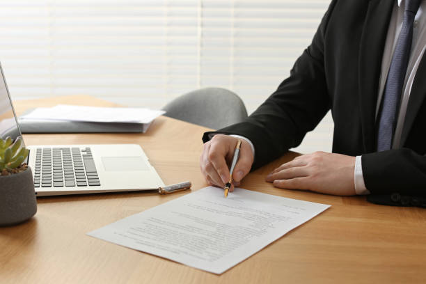 istock Notary signing document at wooden table indoors, closeup 1728648254