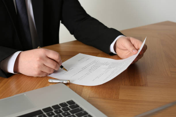 istock Notary signing document at wooden table, closeup 1728648776