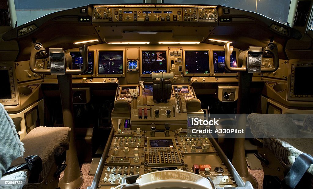 High tech airplane cockpit at night Flight deck illuminated at night. Cockpit Stock Photo