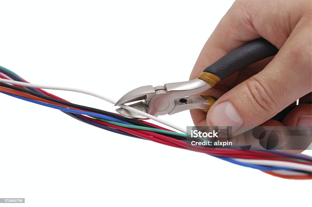 Hand with wire-cutter Hand with wire-cutter cutting a white wire. Isolated on white background with clipping path......................................................................................... Bomb Stock Photo