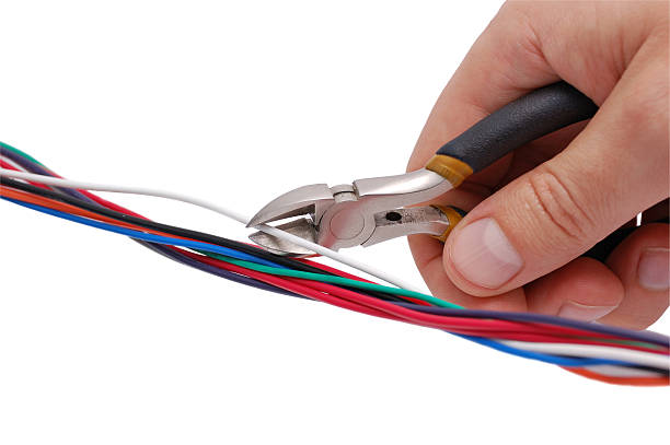 Hand with wire-cutter Hand with wire-cutter cutting a white wire. Isolated on white background with clipping path......................................................................................... wire cutter stock pictures, royalty-free photos & images