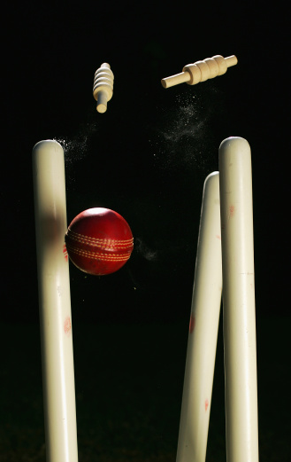 A cricket ball crashes through a set of stumps