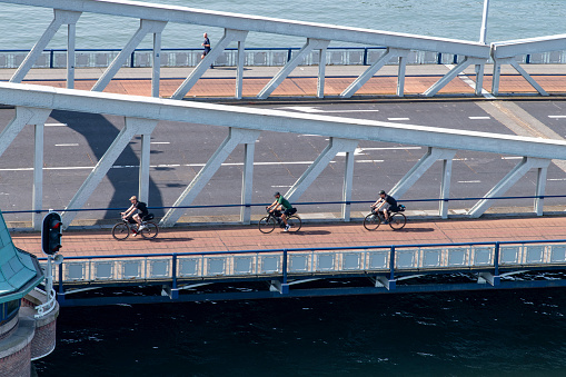 Rotterdam, the Netherlands-September 10, 2023; High angle view of people on a bicycle passing over the Koninginnebrug in the Koningshaven