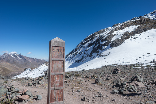 informative sign with 5200 meters above sea level with a snowy background