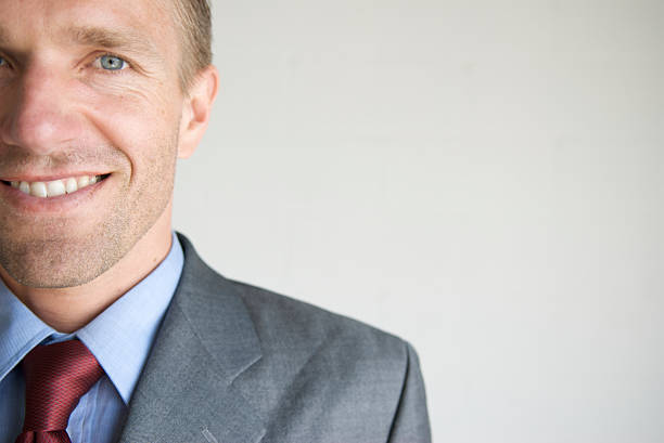 Smiling businessman standing against white background