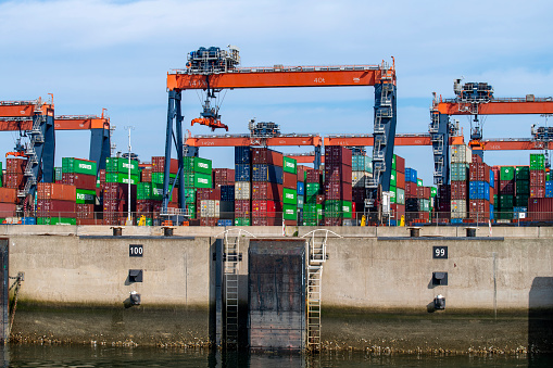 Rotterdam, the Netherlands-September 16, 2023; View of quay of container terminal at low tide with cranes handling containers for further transport by train or truck at Hutchison Ports ECT Euromax