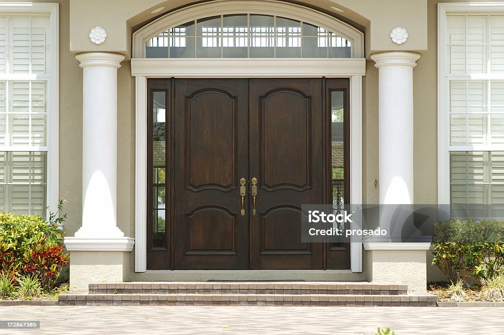Elegant Entry to Luxury Home Entry way with arched window and columns Door Stock Photo