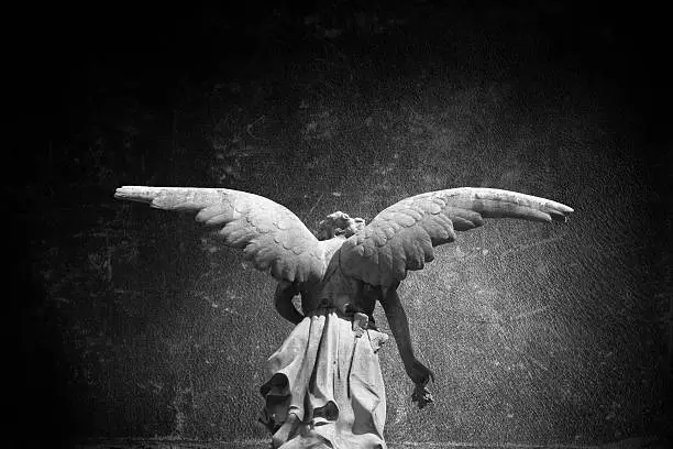 Angel sculpture in public cemetery of ¨Recoleta¨.(Buenos Aires, Argentina), with a grunge texture background.
