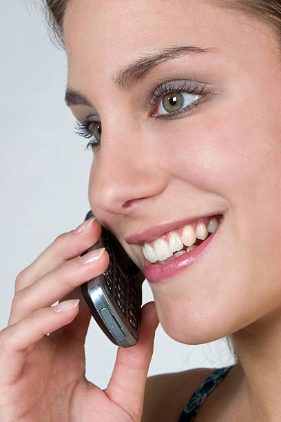 Portrait, smiling pretty girl face Beautiful smiling female, girl on the mobil phone, white teeth, isolated on white background ... http://istock.sk-websolutions.at/img/istock-banner-jr11.jpg jacraa2007 stock pictures, royalty-free photos & images