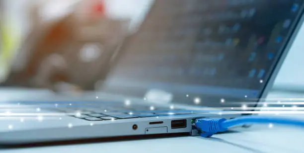 Photo of close up on computer port interface with blue line lan cable connected to transfer bandwidth and usage internet data to global network for internet technology transmission service concept