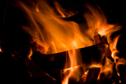Wooden log burning in a fire