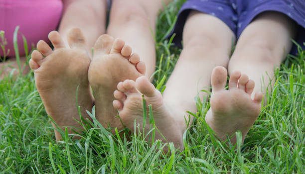 istock Children's legs on green grass. Selective focus. 1728692496