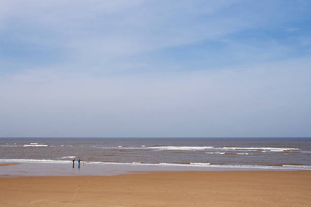 istock Sheringham beach with unrecognisable people walking a dog 172869392