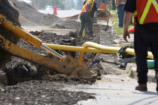 Installation of  a natural gas pipeline under a city street.