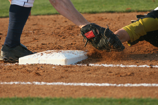 Baseball runner sliding into third base