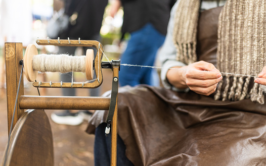 An old style traditional wool spinning machine in action close up.