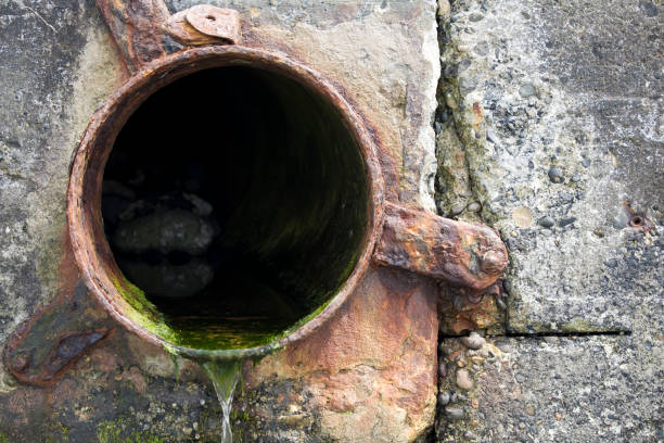 istock Waste drain pipe in concrete wall; environmental damage 172871450