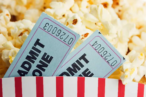 Photo of Movie Ticket Stubs and Popcorn Snack for Film Entertainment Event