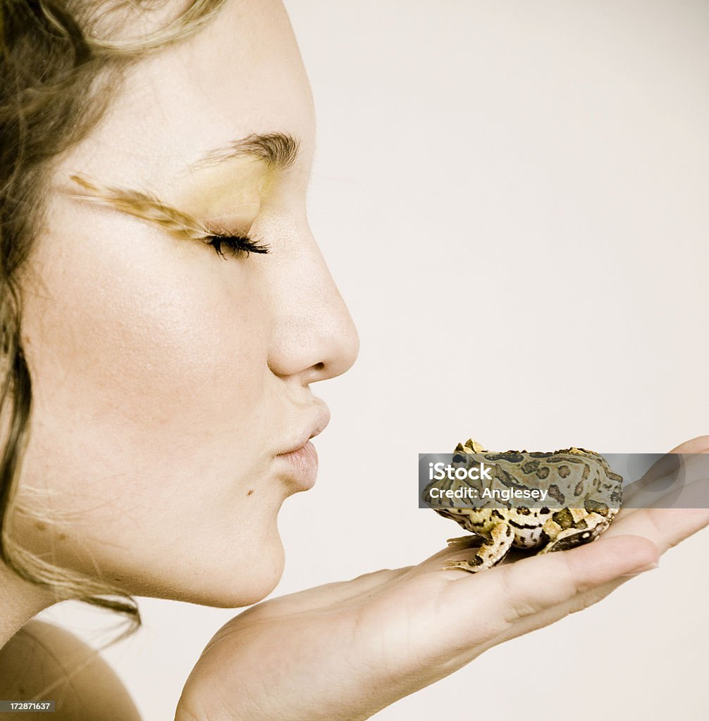 hoping for a prince princess kissing a frog Beautiful People Stock Photo