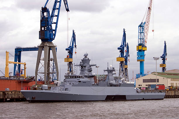 New battleship Battleship in Hamburg harbor. level luffing crane stock pictures, royalty-free photos & images