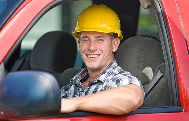 istock A handsome construction worker smiles inside a red truck 172872169
