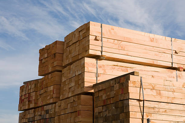 Stack of lumber in lumberyard or construction site stock photo