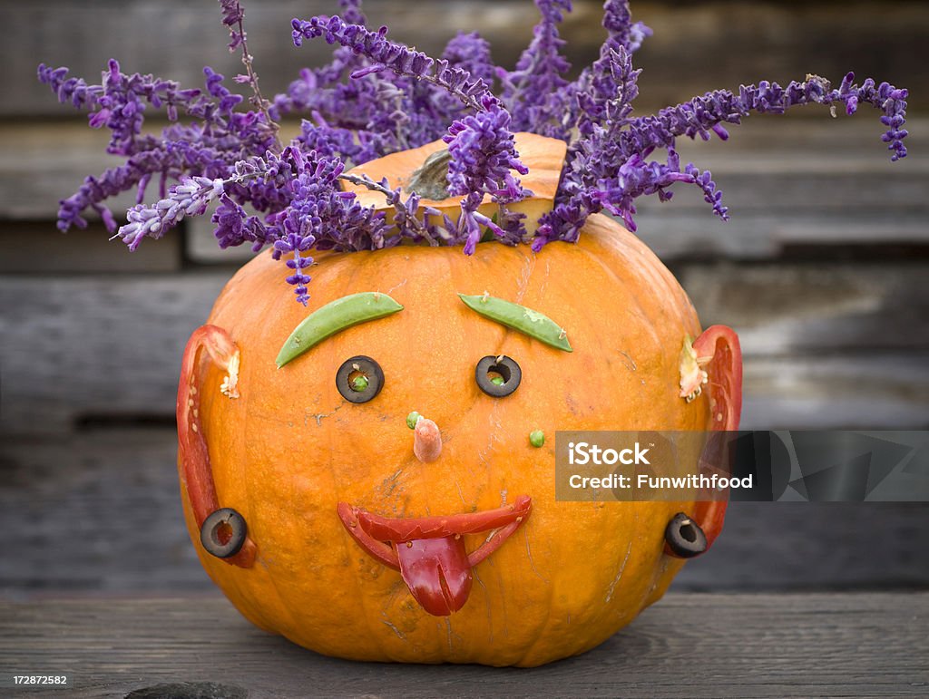 Halloween Pumpkin: Carved Jack o' Lantern Autumn Porch Decoration & Food Halloween pumpkin: Autumn carved jack-o-lantern  with pepper smile & olive eyes on house front porch. (SEE LIGHTBOXES BELOW for more holiday food backgrounds...) Pumpkin Stock Photo