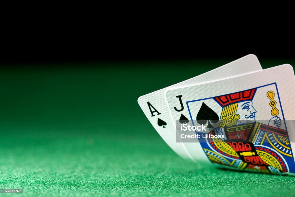 Cards (XL) Black jack on a poker table against a black background and selective focus. Blackjack Stock Photo