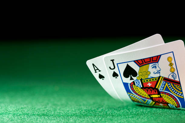 Cards (XL) Black jack on a poker table against a black background and selective focus. ace photos stock pictures, royalty-free photos & images