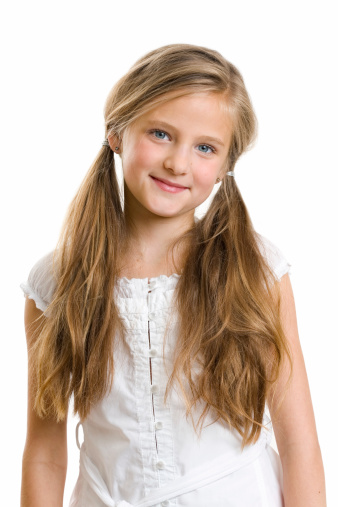 Portrait of attractive caucasian little child girl with blond curly hair and cute smile. Happy smiling child looking at camera - close-up, outdoors.