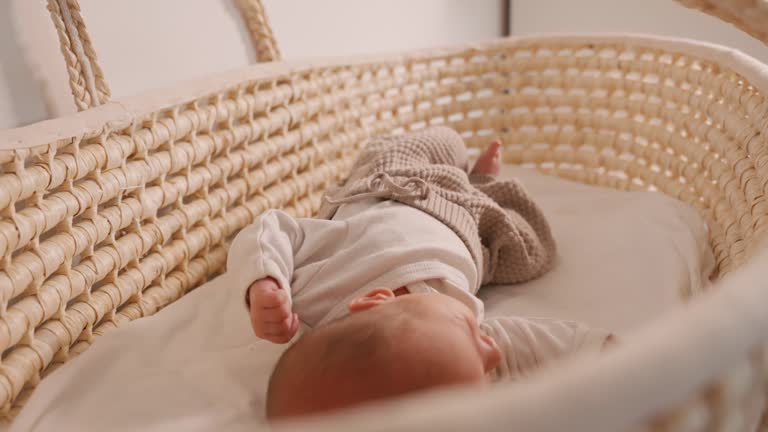 SLO MO Cute Newborn Baby Girl Resting Comfortably in Wicker Basket at Home