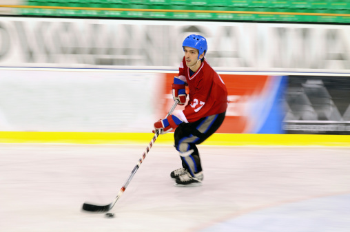 Ice hockey player in motion (blurred motion)