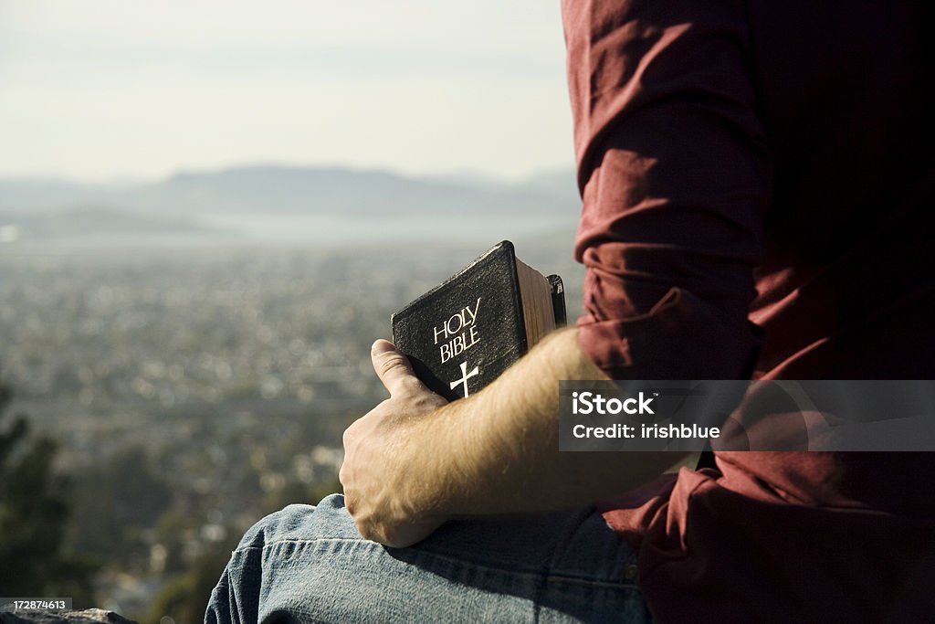 Bible and a view man thinking on a cliff with the bible Bible Stock Photo