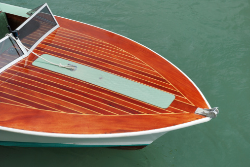 Varnished wooden deck of motor launch.