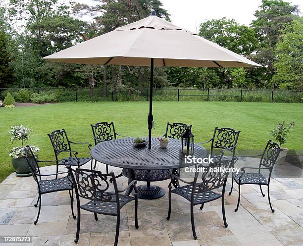 Black Metal Patio Furniture Set With Tan Umbrella Stock Photo - Download Image Now - Patio Umbrella, Umbrella, Table