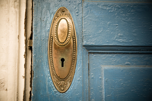 Close up of a round, golden metal door knocker