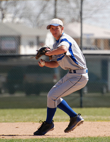 A baseball infielder gets ready to throw the ball.