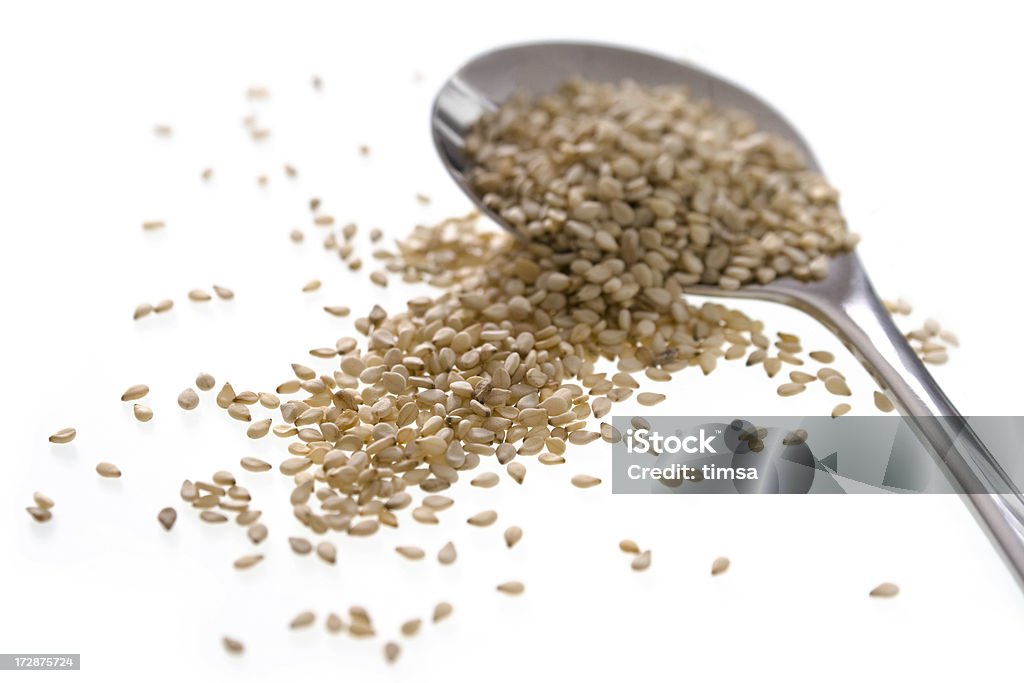 Sesame seeds and small serving spoon Sesame seeds and small serving spoon. More food isolated on white: Cut Out Stock Photo