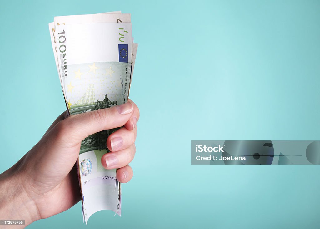 Fistful Of Euros Woman with a fistful of Euros on a blue background. Adult Stock Photo