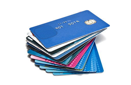 Plastic money or credit/debit cards in different colours compound oin a stack. Copyright and trademark details removed