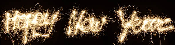 Happy new year written in fireworks on a black background stock photo