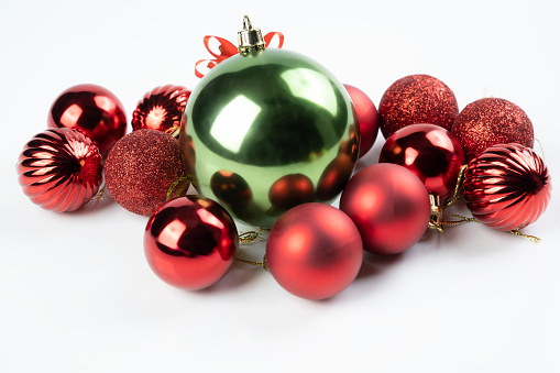 Christmas baubles in red and gold in a row isolated on white