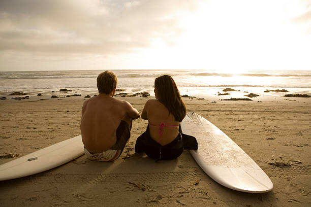Surfers Watching Sunset stock photo
