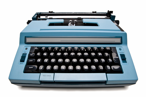 Antique blue electric typewriter isolated on white
