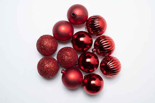 A red Christmas ball on a white background. Christmas decoration concept
