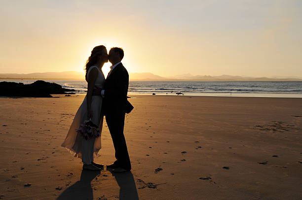 istock Wedding couple kissing on the beach at sunset 172879245