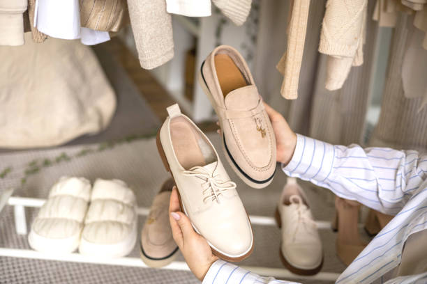 istock Modern woman choosing shoes putting on rack wardrobe comfortable storage organizing top view 1728809837